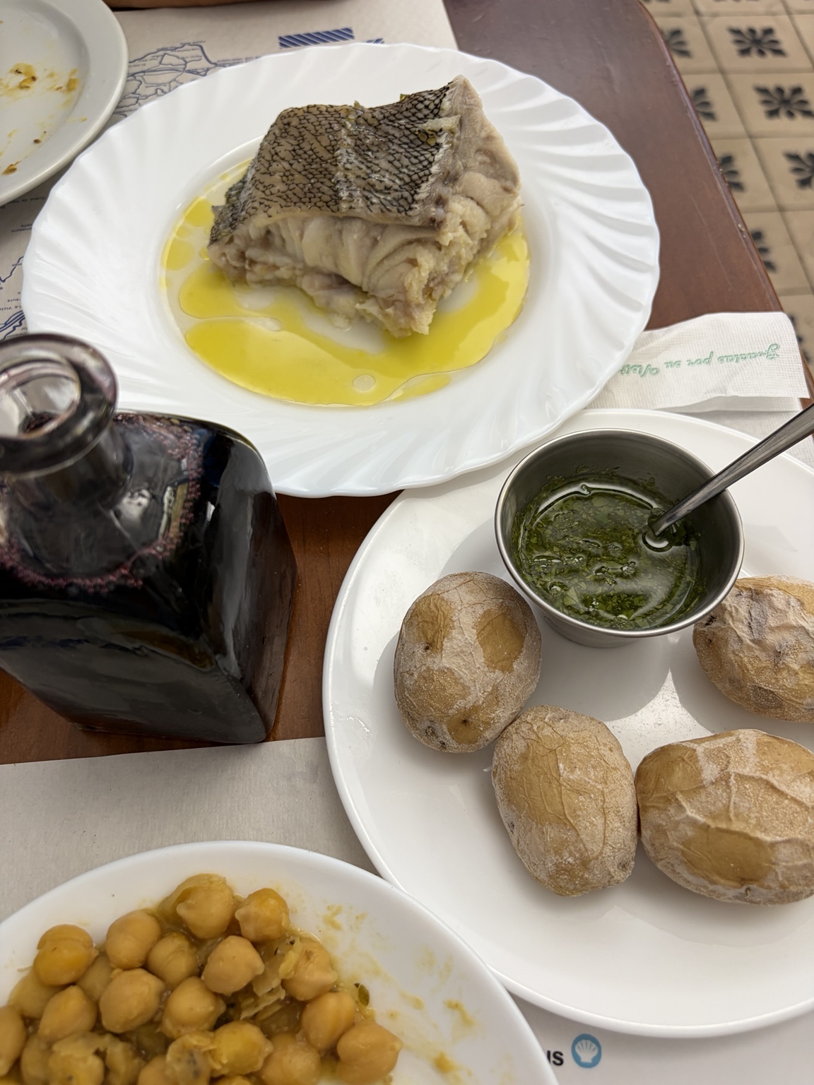 A Canarian table with fresh fish, bread, potatoes and mojo sauce
